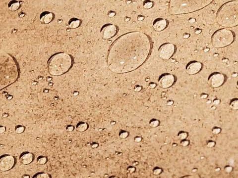 Water beading up on a surface treated with a water repellent