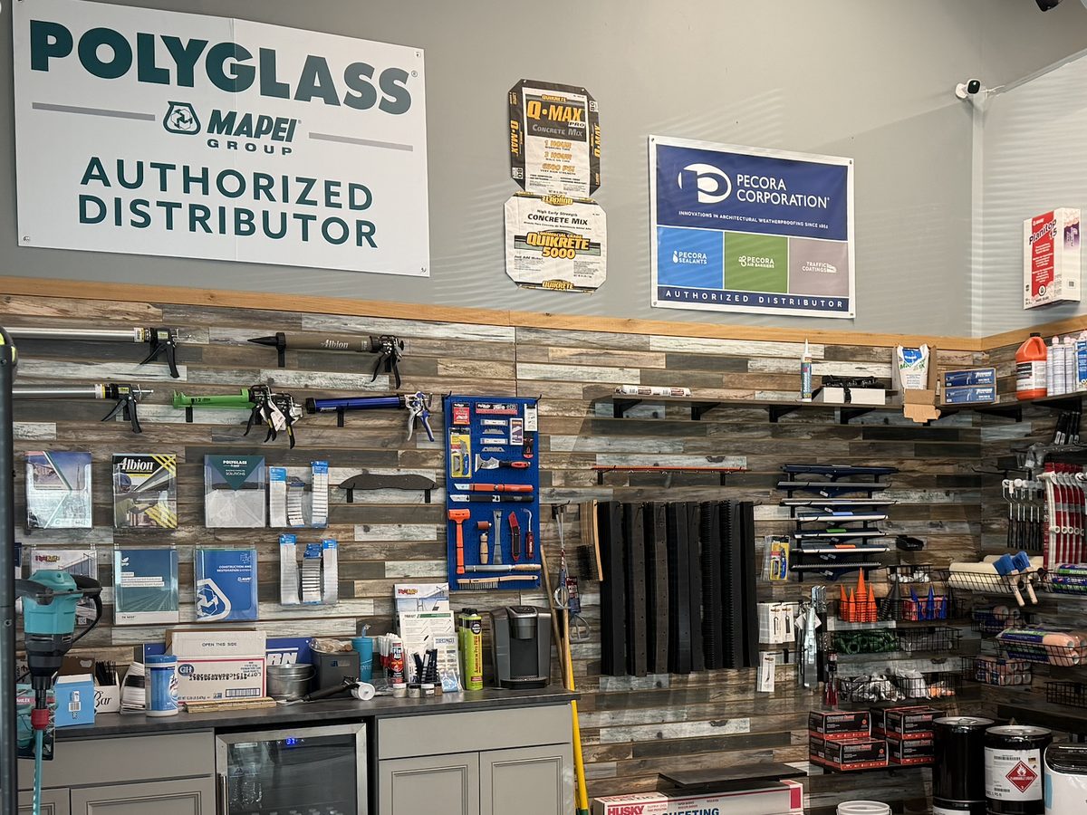 The Altitude showroom in Littleton: caulk guns, tools and accessories on the wall under the Polyglass and Pecora authorized distributor signs