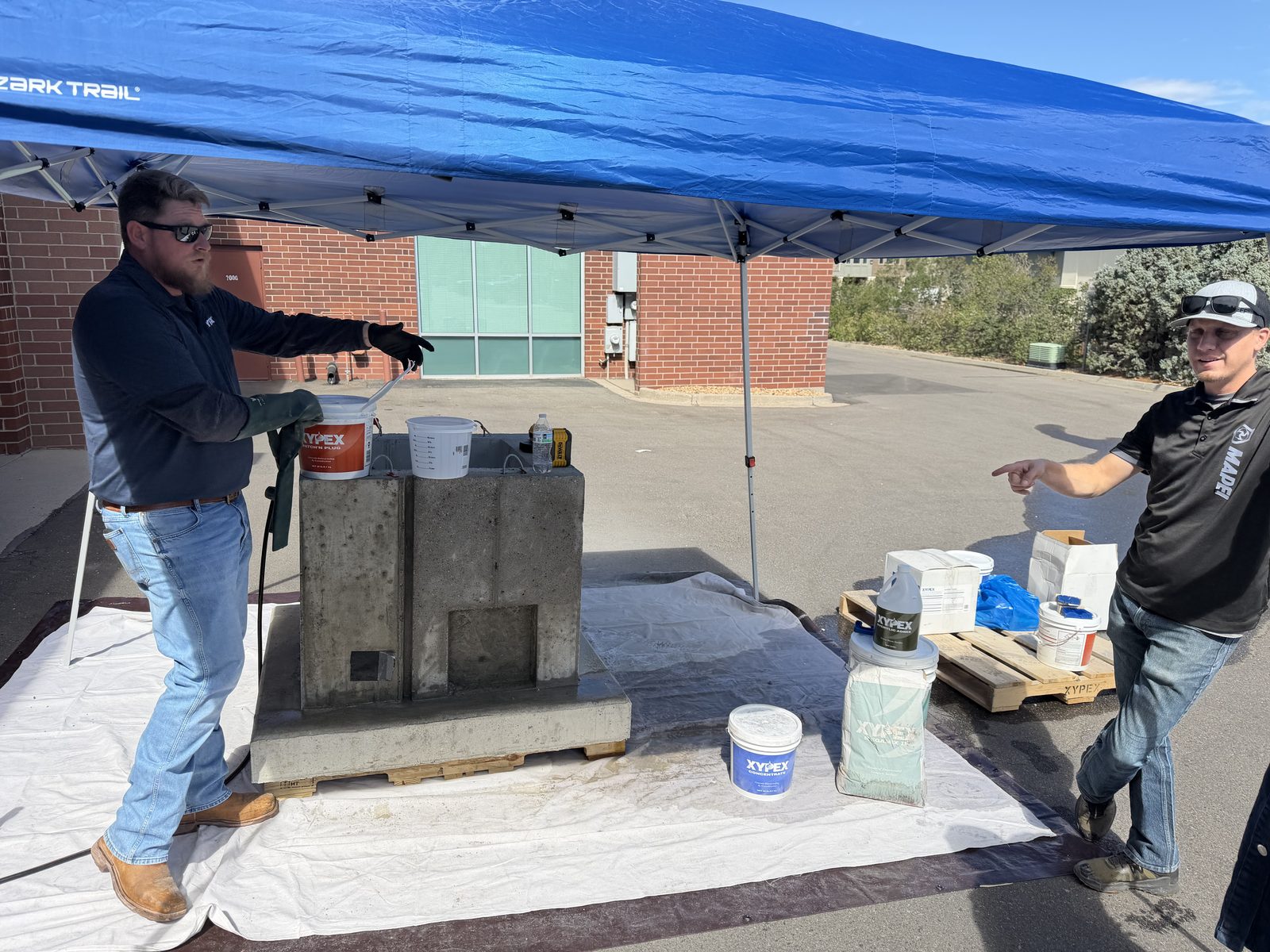 Crystalline waterproofing being demonstrated on a concrete test block