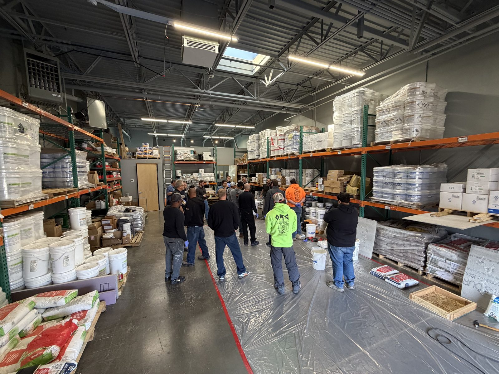 Contractors gathered for a product training session among stocked shelves